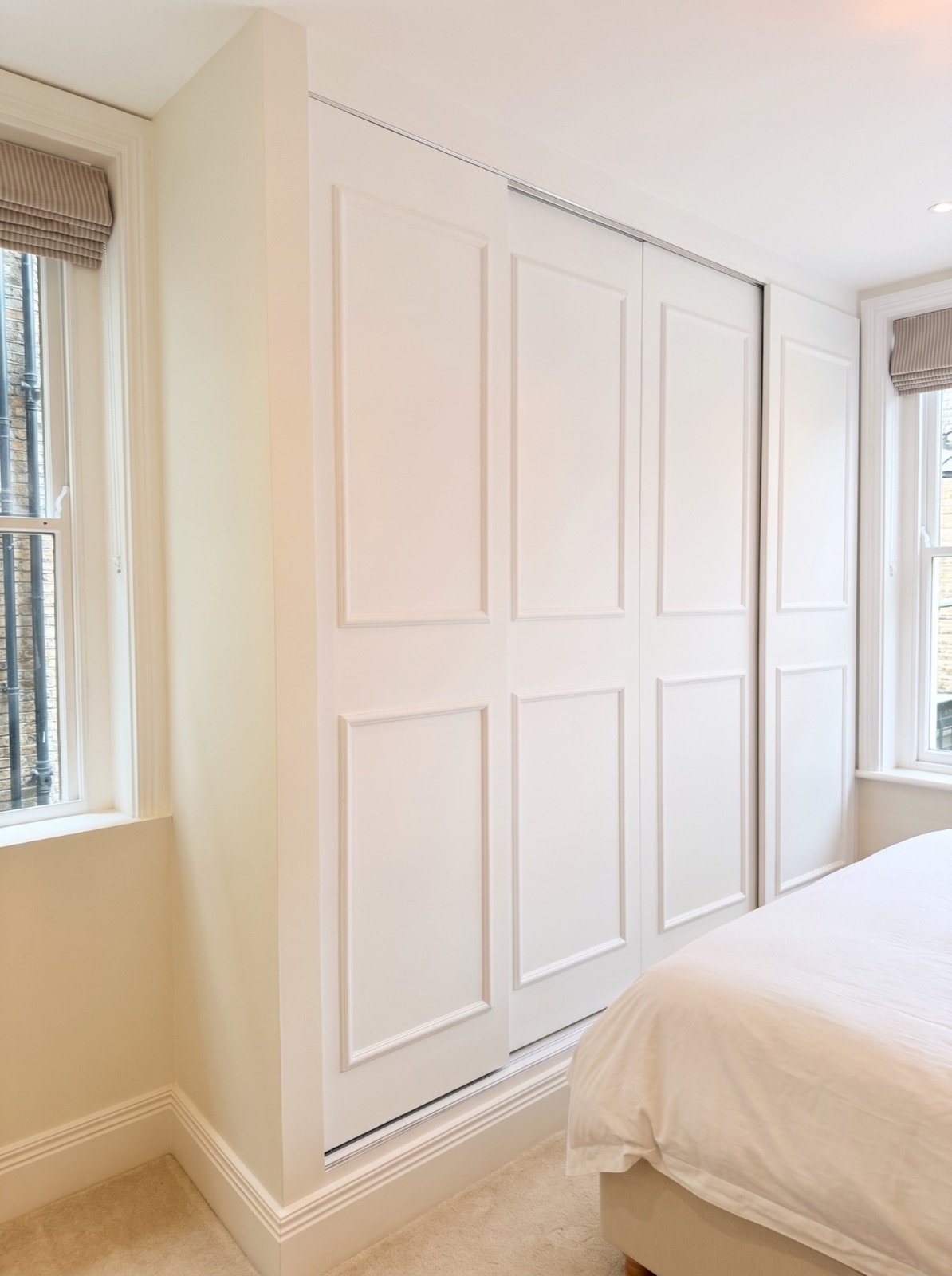 Built-in sliding wardrobe with panelled doors in the main bedroom